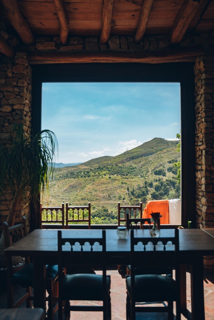 A table at the big window, the hills beyond