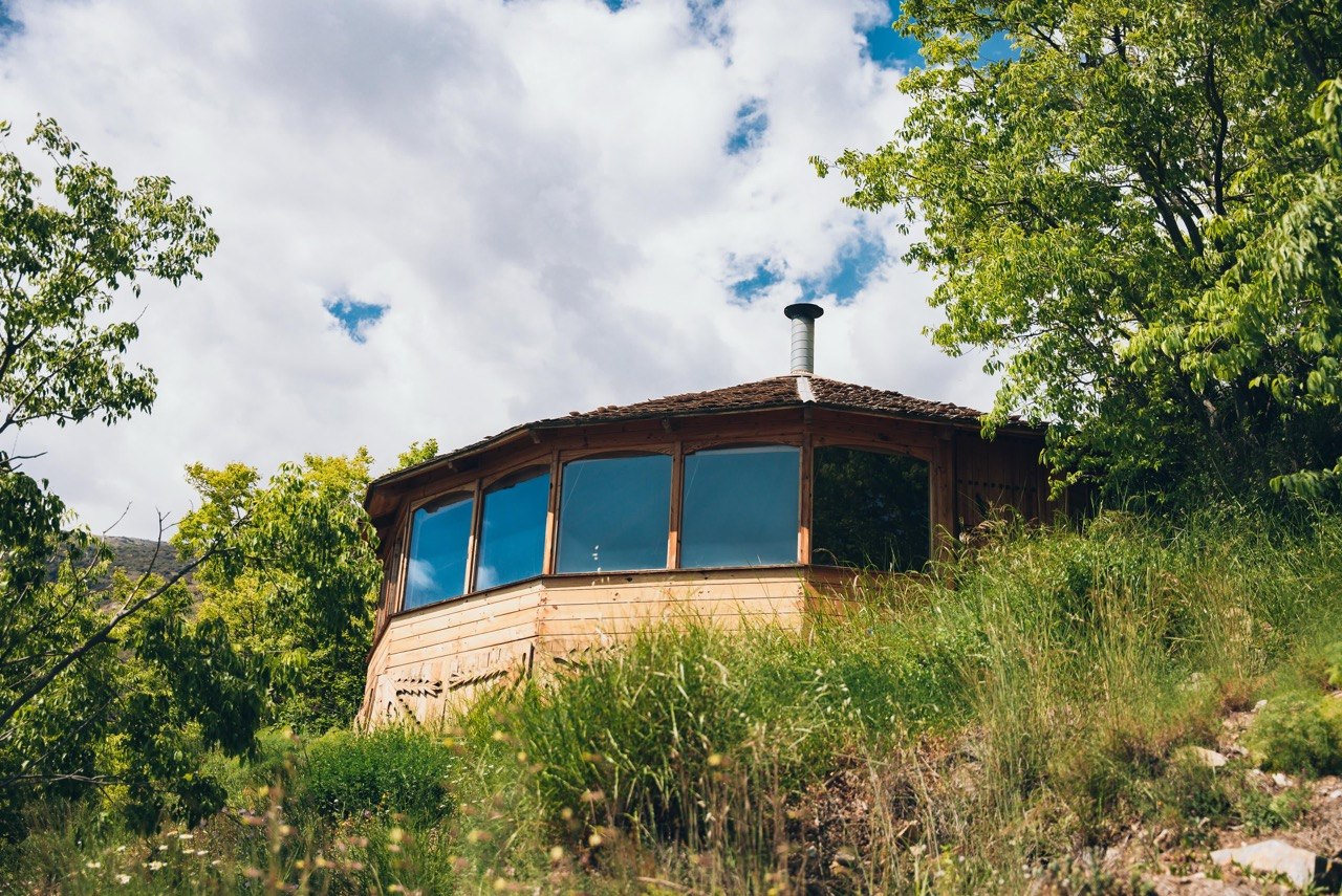 A wooden house in the long grass